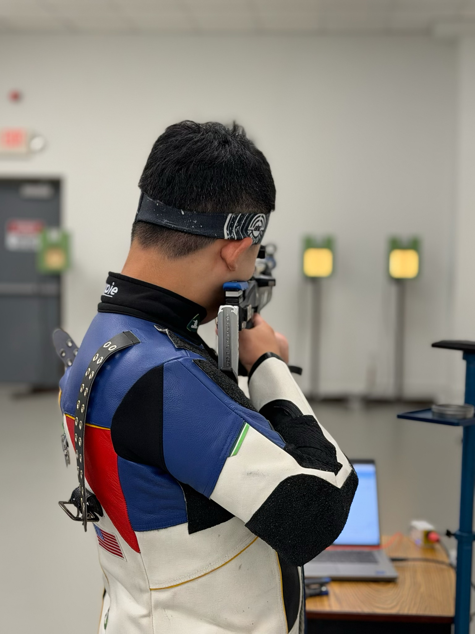Sky Arc precision athlete aiming an air rifle during focused training