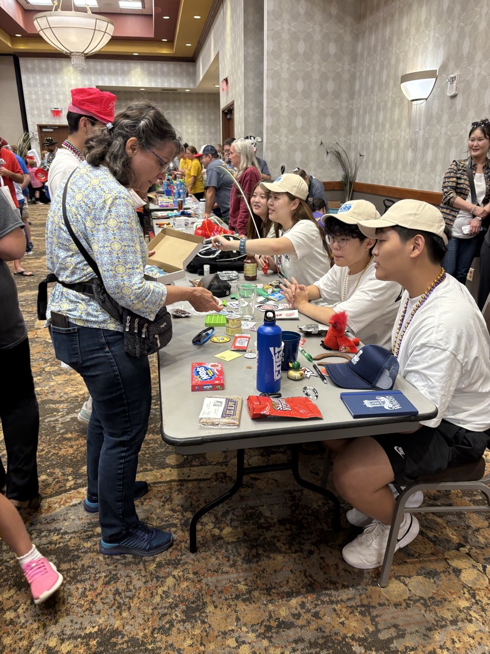 Sky Arc athletes welcoming visitors at a community event table